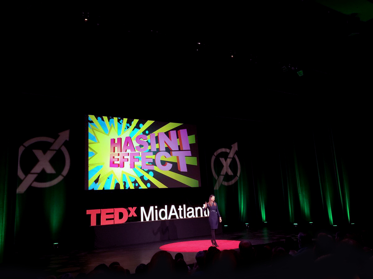 hasini on stage in front of the #hasinieffect image splash