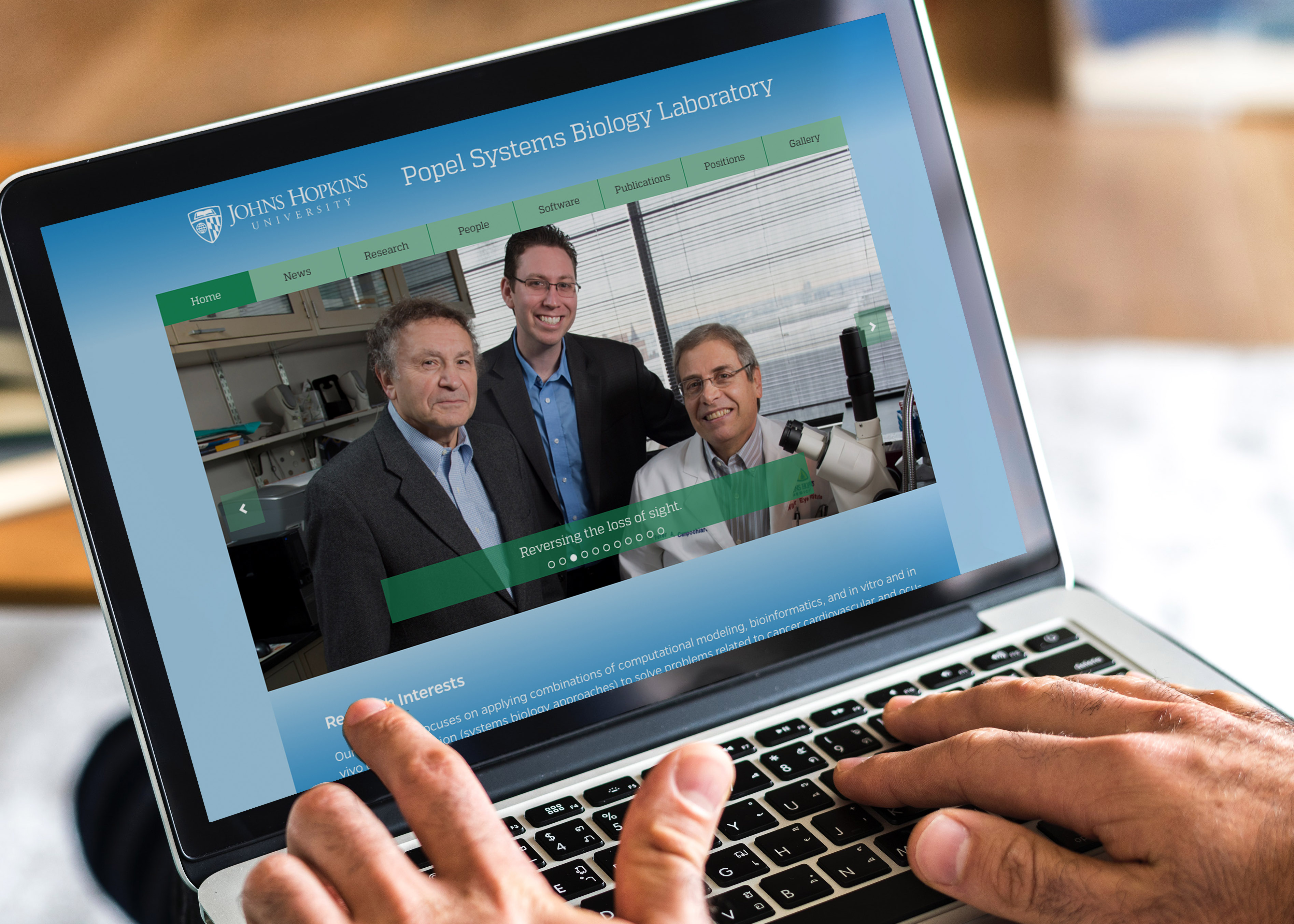 The popel Laboratory website seen on a laptop.